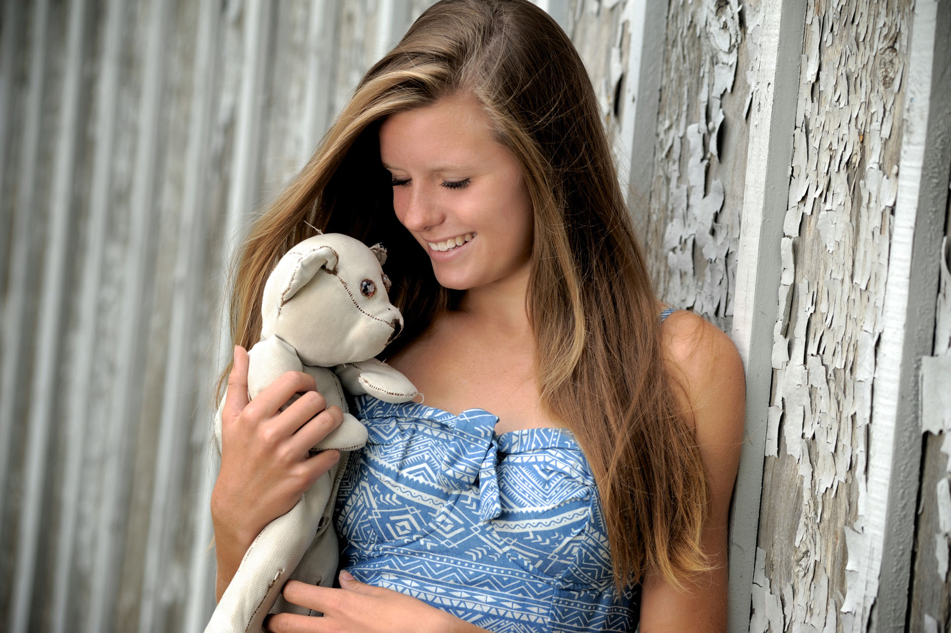 Troy , Michigan senior photographer's photo taken as the high school senior plays with her old stuffed animal for her their senior pictures in Troy, Michigan.